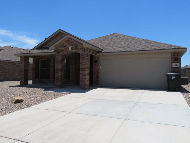 1812 Masquerade Blvd, Odessa, TX 79765 - view of front of house with brick siding, an attached garage, driveway, and a shingled roof