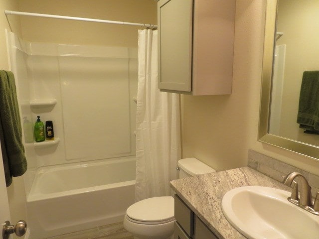 1812 Masquerade Blvd, Odessa, TX 79765 - bathroom featuring toilet, shower / bath combination with curtain, and vanity