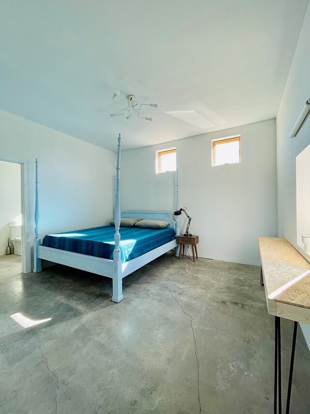 702 E Washington St, Marfa, TX 79843 - bedroom with unfinished concrete flooring