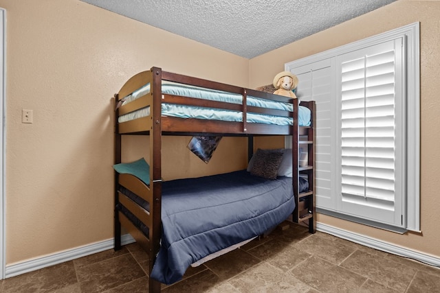 1324 Pagewood Ave, Odessa, TX 79761 - bedroom with a textured ceiling and baseboards