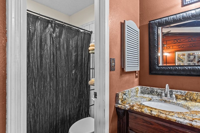 1324 Pagewood Ave, Odessa, TX 79761 - bathroom featuring a textured wall, vanity, and curtained shower