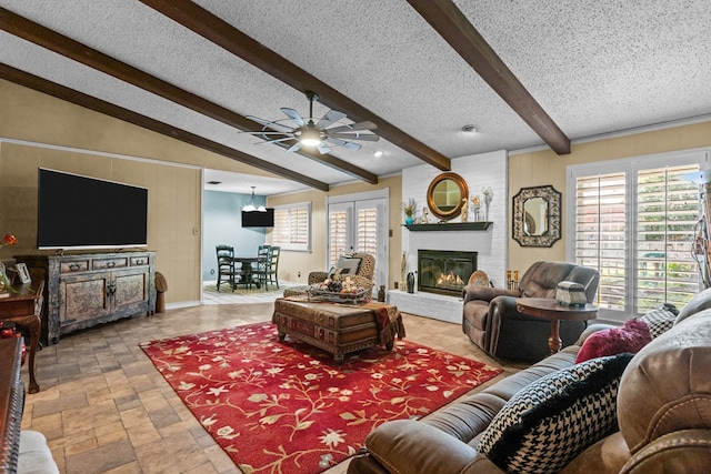 1324 Pagewood Ave, Odessa, TX 79761 - living area with a fireplace, beamed ceiling, ceiling fan, wooden walls, and stone tile floors