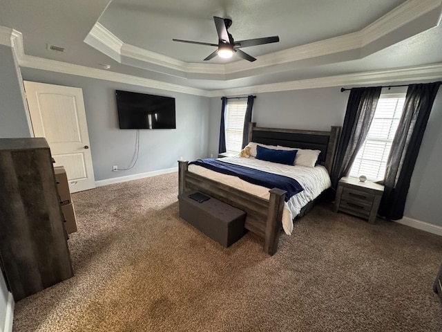 616 96th St, Odessa, TX 79765 - carpeted bedroom featuring a tray ceiling, crown molding, multiple windows, and ceiling fan