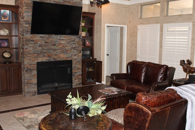 living room featuring tile patterned floors, a stone fireplace, and crown molding