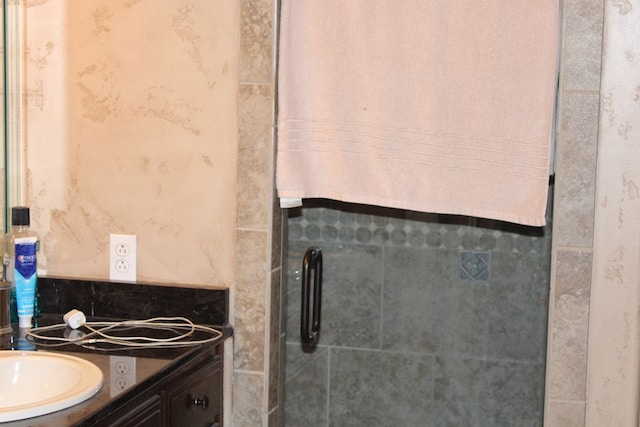 bathroom with vanity, a stall shower, and backsplash
