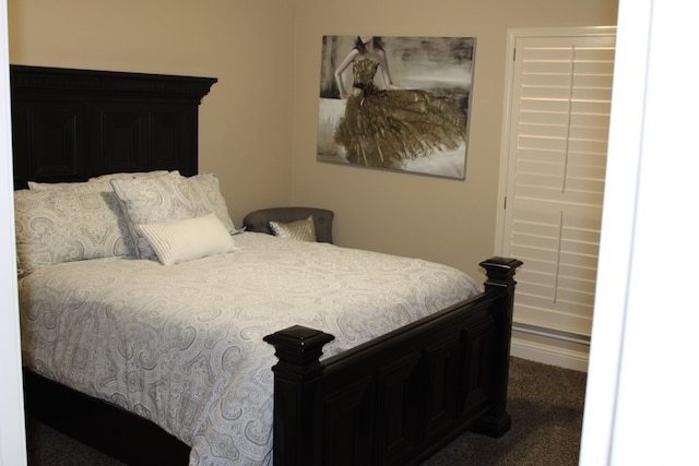 carpeted bedroom featuring baseboards