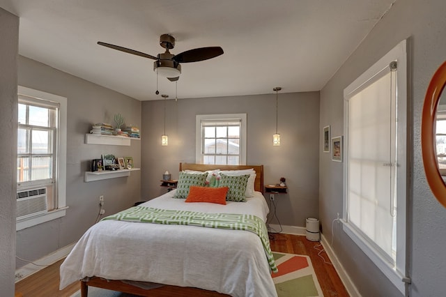 408 W 2nd St, Marfa, TX 79843 - bedroom with wood finished floors, baseboards, cooling unit, and a ceiling fan