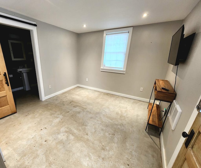 408 W 2nd St, Marfa, TX 79843 - unfurnished bedroom with concrete flooring, baseboards, and recessed lighting