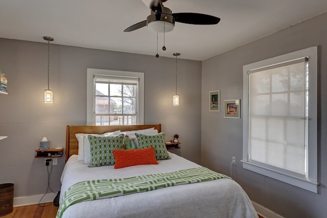 408 W 2nd St, Marfa, TX 79843 - bedroom with wood finished floors, baseboards, and a ceiling fan