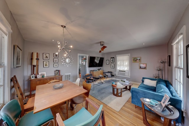 408 W 2nd St, Marfa, TX 79843 - dining area featuring light wood finished floors, healthy amount of natural light, baseboards, and cooling unit