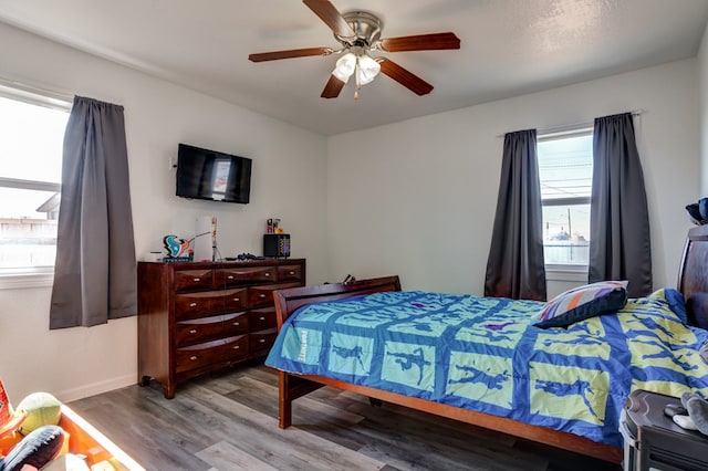 bedroom with ceiling fan and light hardwood / wood-style flooring