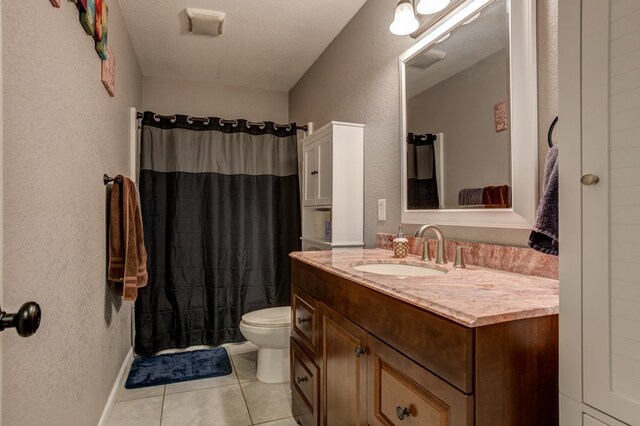 bathroom featuring curtained shower, a textured ceiling, toilet, tile patterned floors, and vanity