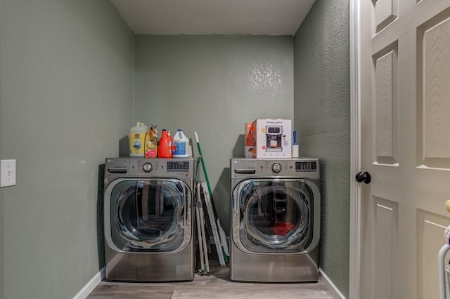 laundry area with wood-type flooring and independent washer and dryer