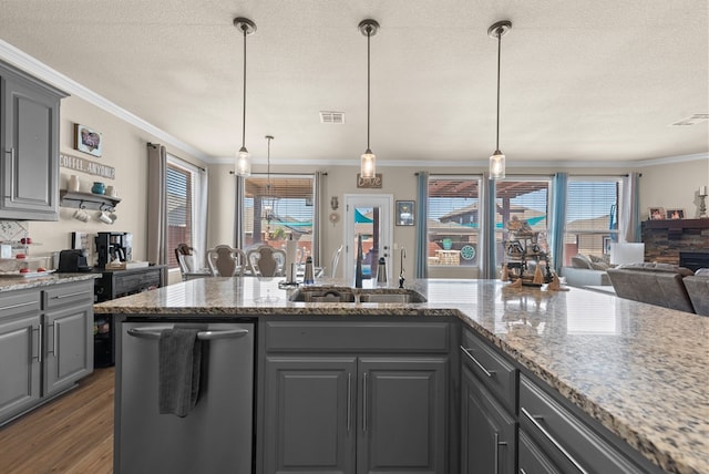 7028 Xit Ranch Rd, Odessa, TX 79765 - kitchen with gray cabinets, a textured ceiling, ornamental molding, open floor plan, and wood finished floors