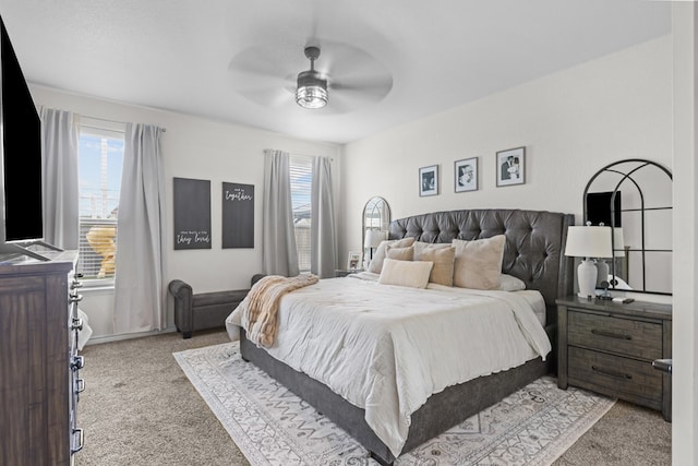 carpeted bedroom with a ceiling fan and multiple windows