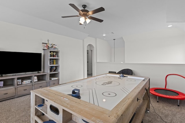 playroom featuring a ceiling fan, carpet flooring, arched walkways, and vaulted ceiling