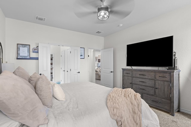 bedroom featuring light colored carpet, ceiling fan, and visible vents