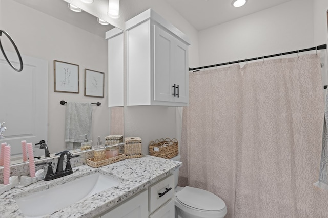 bathroom with vanity, toilet, and a shower with curtain