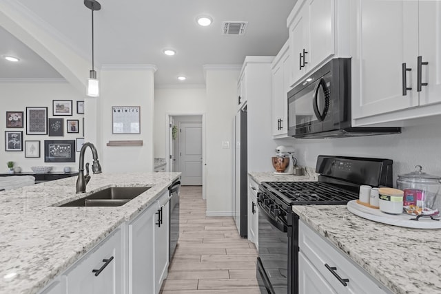 kitchen featuring visible vents, a sink, crown molding, black appliances, and white cabinets