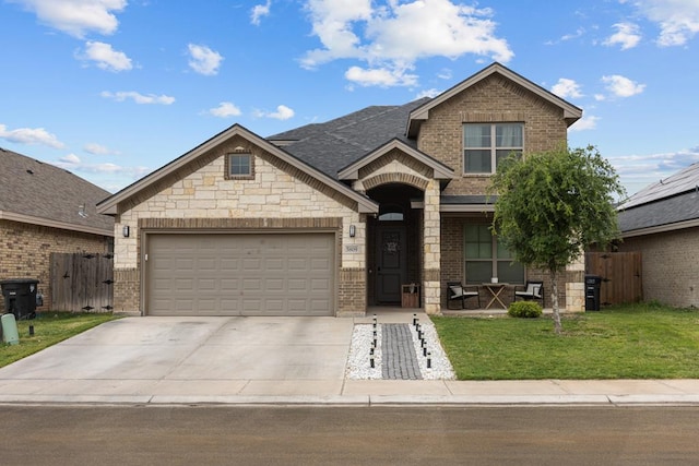 view of front of house featuring a front yard, brick siding, and driveway