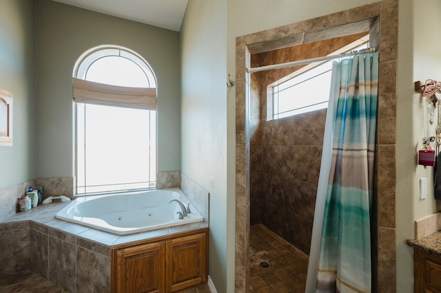 bathroom with plenty of natural light, vanity, and separate shower and tub