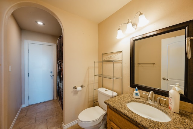 bathroom featuring tile patterned floors, toilet, and vanity