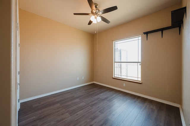 spare room featuring ceiling fan and dark wood-type flooring