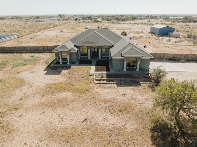 view of front of property with a rural view and a porch