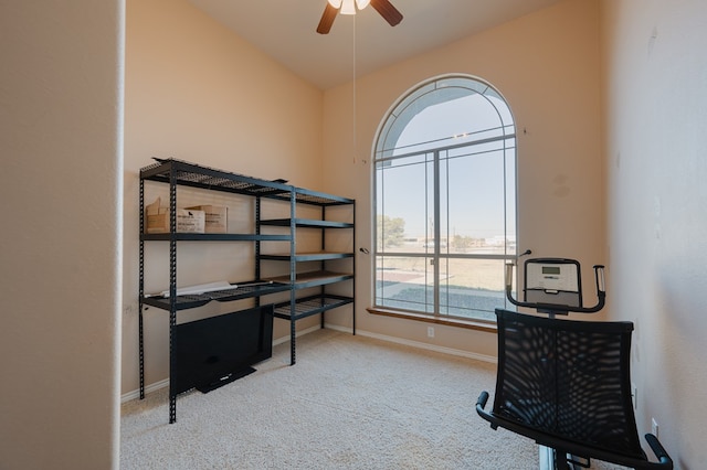 carpeted office with ceiling fan and vaulted ceiling