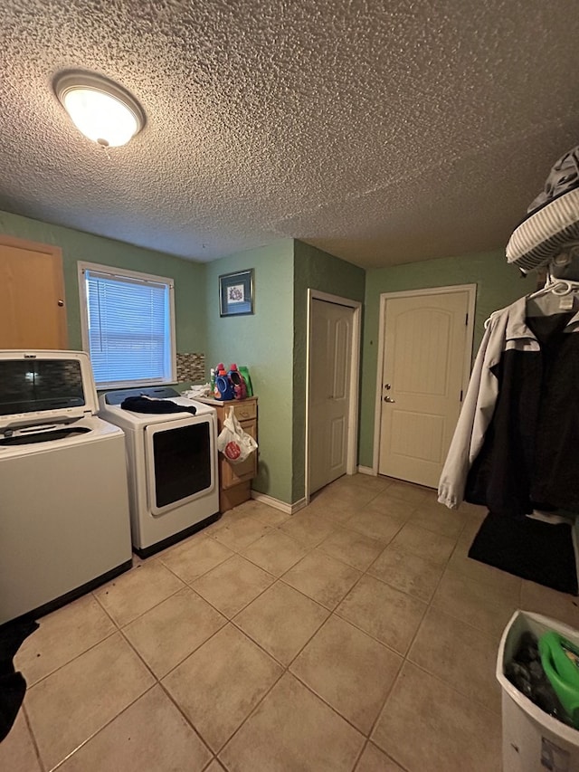 414 E 45th St, Odessa, TX 79762 - clothes washing area with independent washer and dryer, light tile patterned flooring, and a textured ceiling