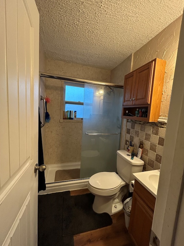414 E 45th St, Odessa, TX 79762 - full bathroom with a stall shower, toilet, a textured ceiling, vanity, and tile walls