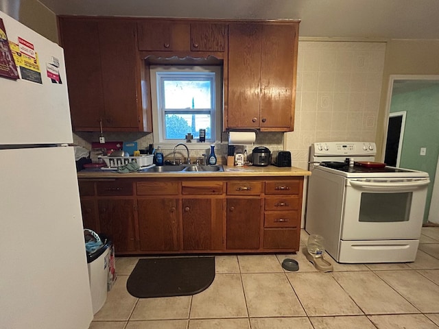 414 E 45th St, Odessa, TX 79762 - kitchen featuring white appliances, a sink, light tile patterned floors, and light countertops