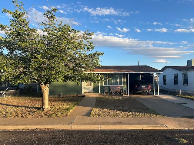 414 E 45th St, Odessa, TX 79762 - view of front facade with concrete driveway, a carport, fence, and cooling unit