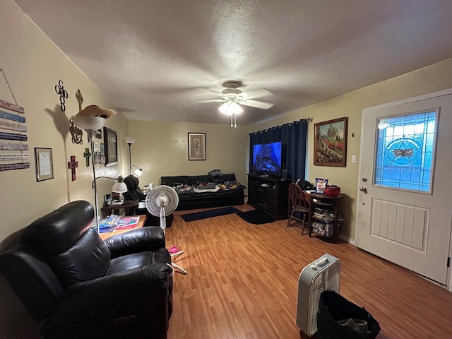414 E 45th St, Odessa, TX 79762 - living room with light wood-type flooring, ceiling fan, and a textured ceiling