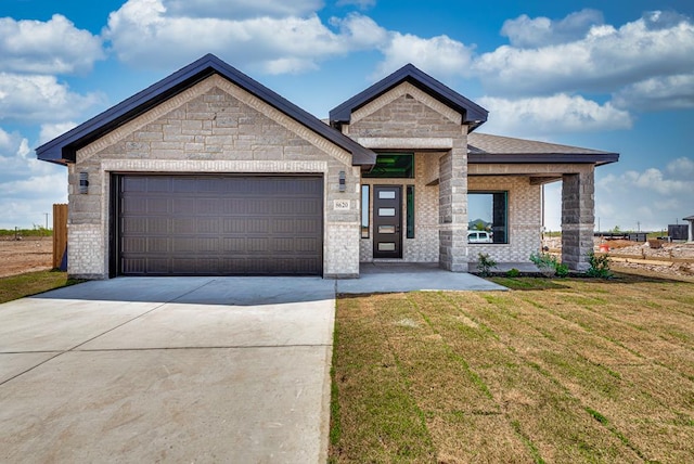 8620 Santa Isabella St, Odessa, TX 79765 - view of front facade with driveway, a garage, a front yard, and brick siding