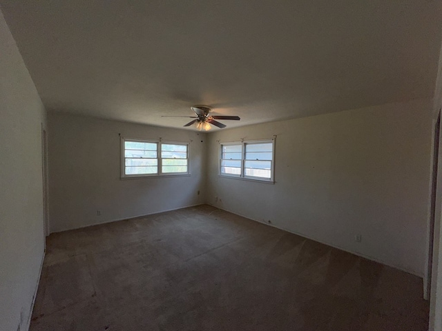 unfurnished room featuring carpet and a ceiling fan