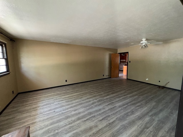 unfurnished living room with baseboards, ceiling fan, and wood finished floors
