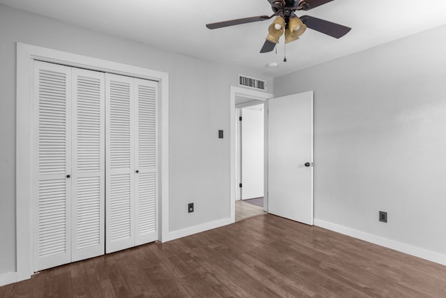 unfurnished bedroom with wood finished floors, baseboards, a closet, and ceiling fan