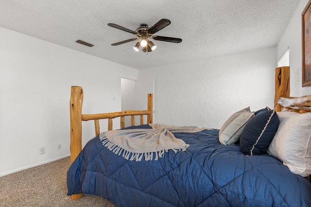 carpeted bedroom with a textured ceiling and ceiling fan