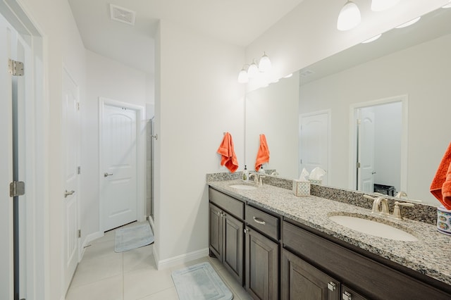 7521 Iron Mountain Rd, Odessa, TX 79765 - bathroom with double vanity, tile patterned floors, and baseboards