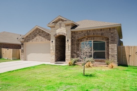 7521 Iron Mountain Rd, Odessa, TX 79765 - french country style house with brick siding, a garage, and concrete driveway