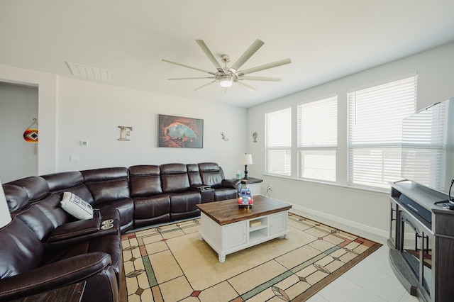 7521 Iron Mountain Rd, Odessa, TX 79765 - living area with ceiling fan, light tile patterned flooring, and baseboards