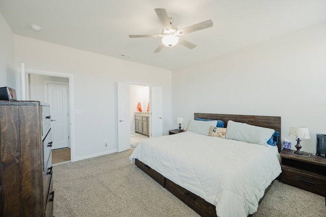 7521 Iron Mountain Rd, Odessa, TX 79765 - bedroom featuring light colored carpet, baseboards, ceiling fan, and ensuite bath