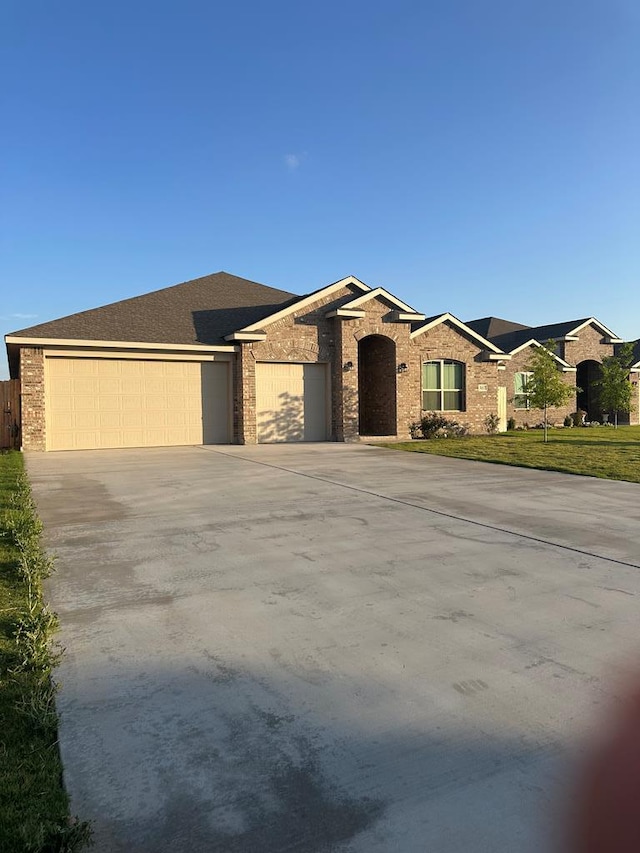 3117 Blue Quail Ct, Midland, TX 79705 - view of front of property featuring an attached garage, driveway, and brick siding