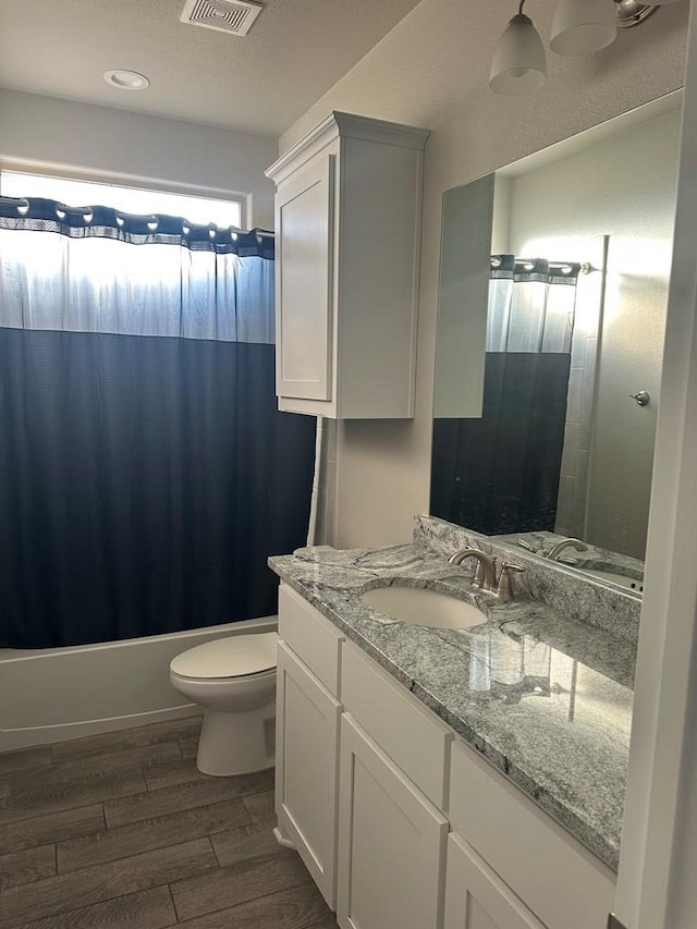 3117 Blue Quail Ct, Midland, TX 79705 - full bath featuring vanity, toilet, wood finished floors, and shower / bath combination with curtain