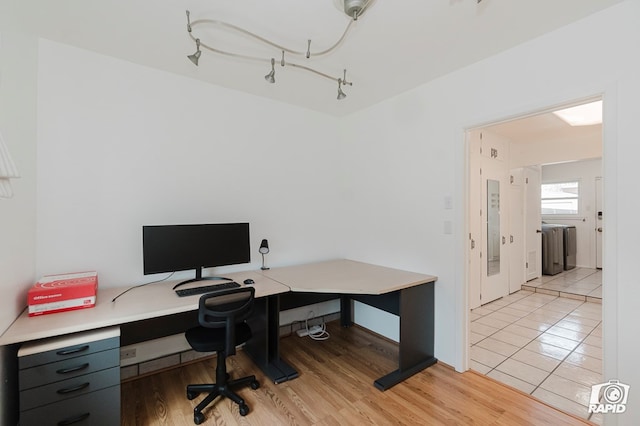 home office featuring washer / dryer and light wood-type flooring