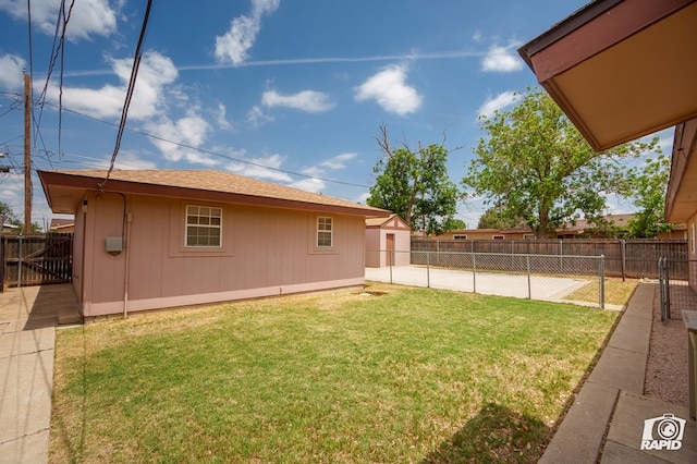 view of yard featuring fence and an outdoor structure