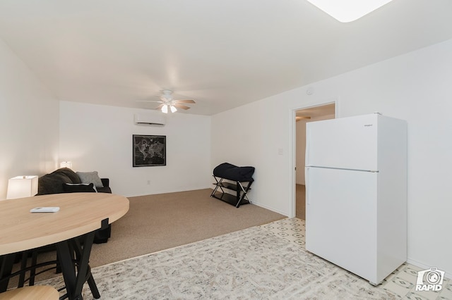 interior space featuring baseboards, light carpet, a wall mounted air conditioner, and ceiling fan