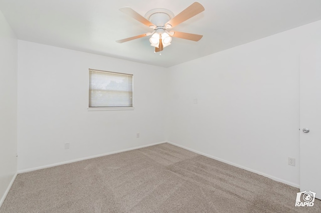 unfurnished room featuring carpet flooring, baseboards, and a ceiling fan