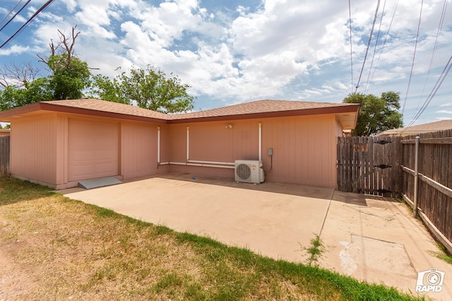 rear view of property featuring ac unit, a patio, fence, and a gate